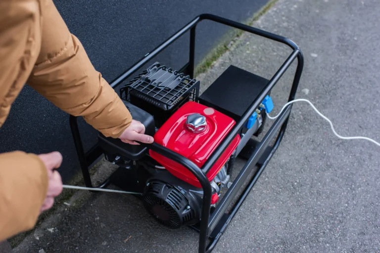 Man starting a portable generator during a power outage.