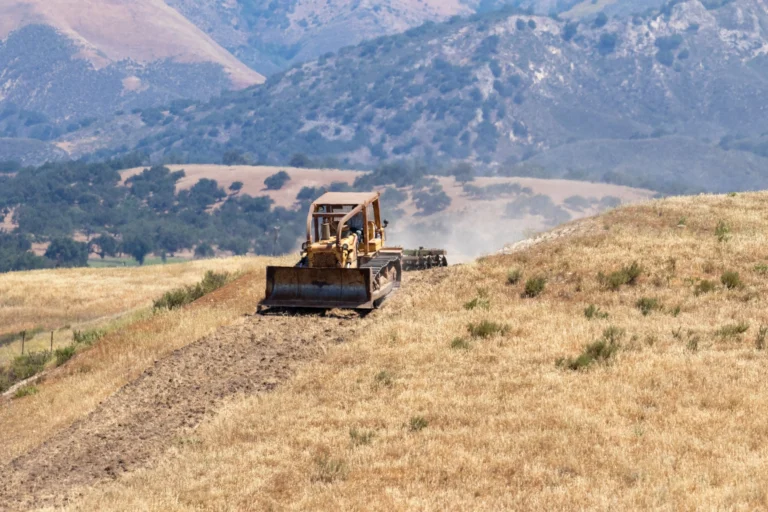 Bulldozer creating a firebreak for wildfire prevention.